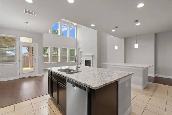 a view of a kitchen with granite countertop cabinets