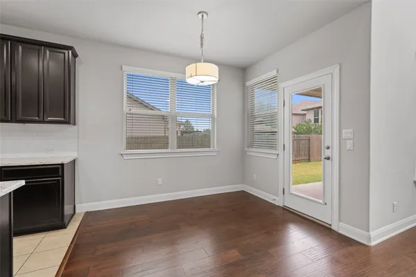 a view of empty room with wooden floor and fireplace