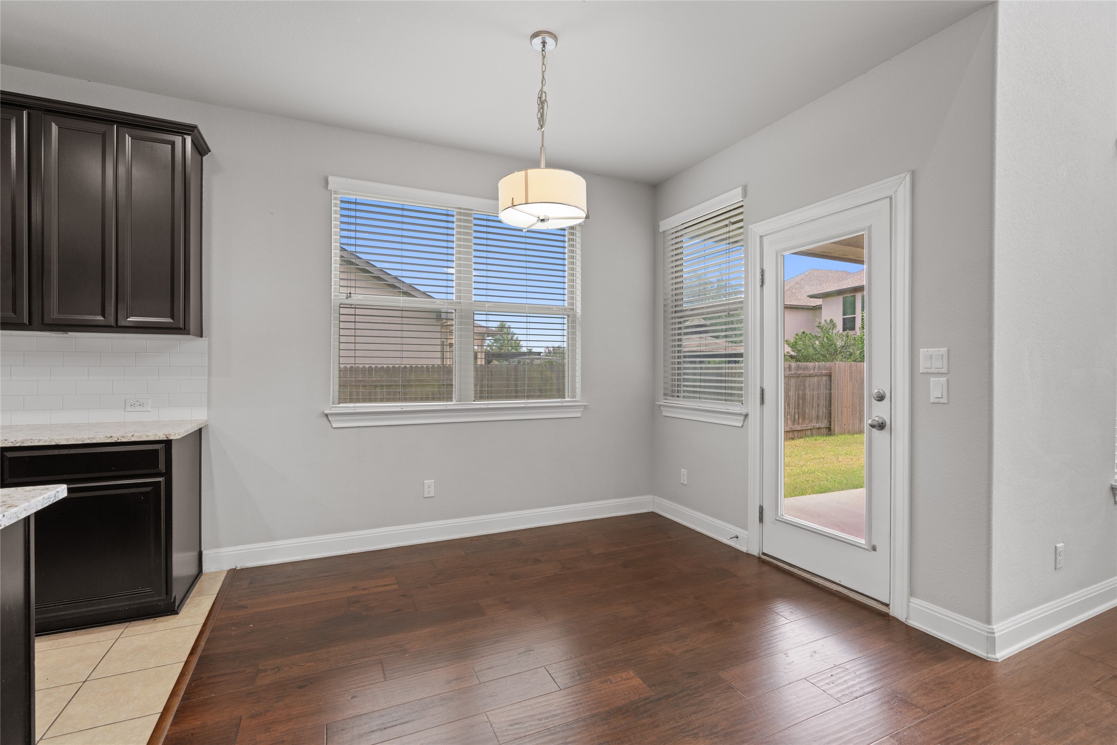 15601 Cabrillo Way Austin, TX 78738 - Photo 17 of 32 Dining area featuring wood-finish flooring and a contemporary pendant light fixture