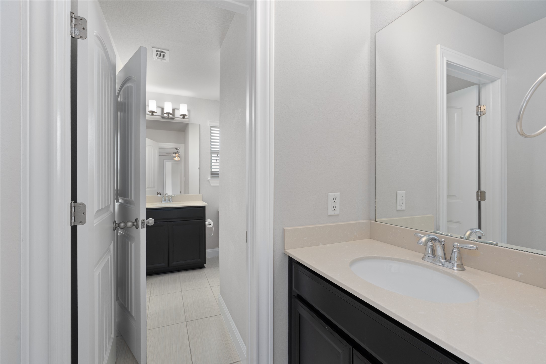 15601 Cabrillo Way Austin, TX 78738 - Photo 27 of 32 Bathroom vanity featuring a light-toned countertop, undermount sink, and chrome fixtures