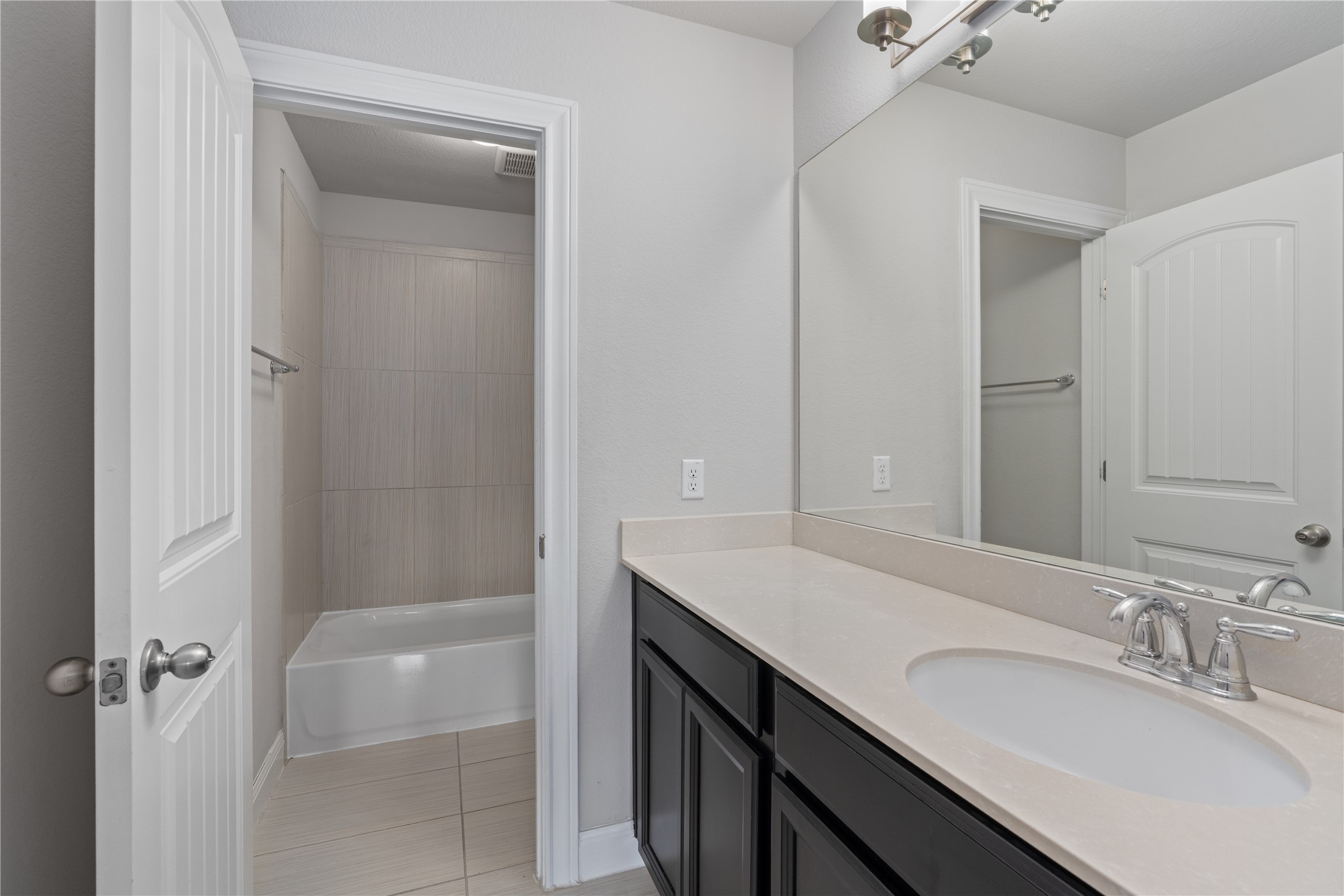 15601 Cabrillo Way Austin, TX 78738 - Photo 29 of 32 Bathroom featuring a single vanity with dark cabinetry, an undermount sink, and a light-toned countertop