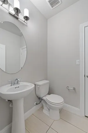 a white toilet sitting next to a bathroom sink