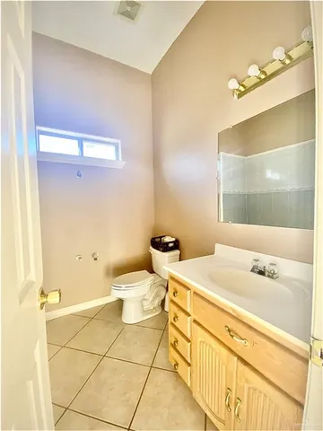 an empty room with a fireplace and windows