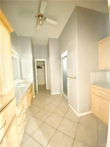 a large bathroom with a large tub and sink