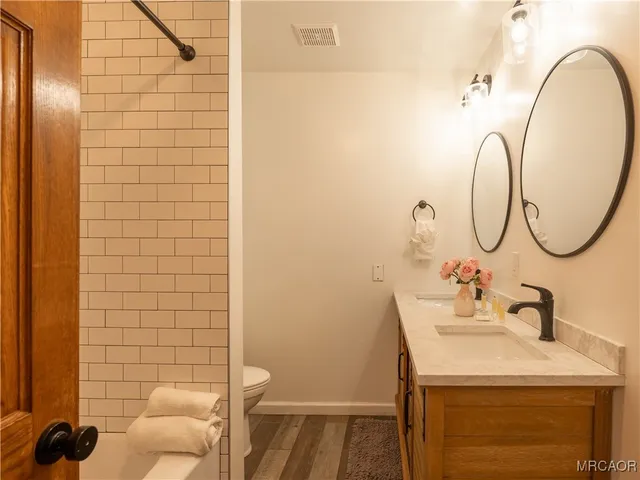 a view of a swimming pool with a patio and a yard