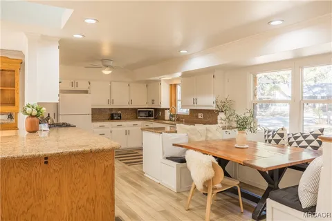 a view of balcony with furniture and wooden floor