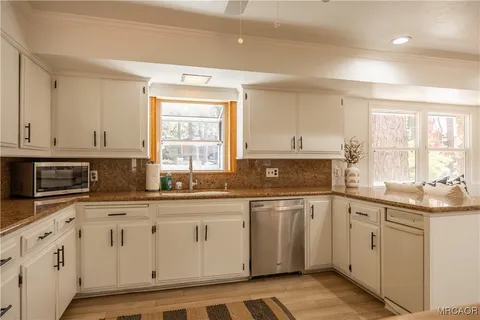 a bathroom with a double vanity sink mirror and shower