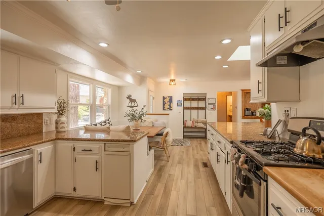 a spacious bedroom with a bed and wooden floor