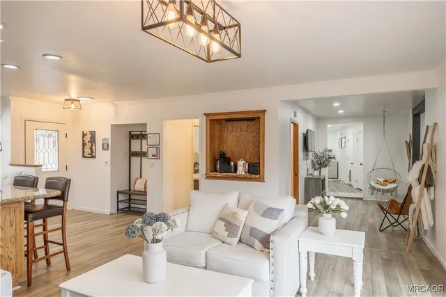 a spacious bedroom with two beds and a flat screen tv