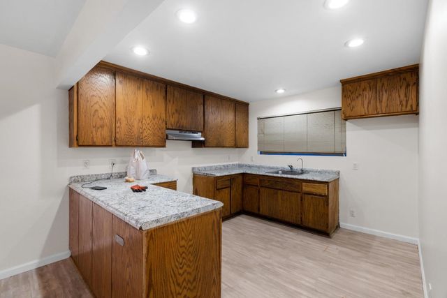 a view of a room with wooden floor and ceiling fan