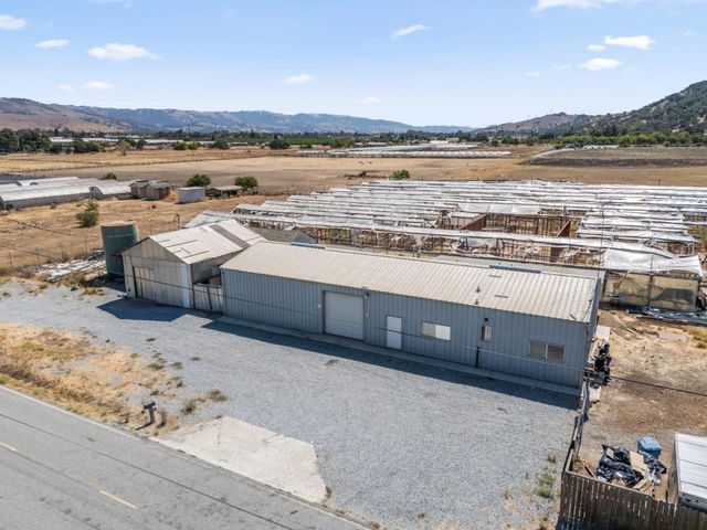 a view of a terrace with lawn chairs and ocean view
