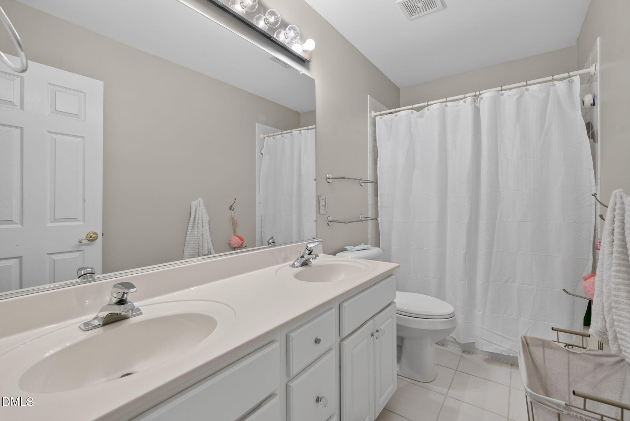 1258 Horsham Way Apex, NC 27502 - Photo 20 of 32 a bathroom with a double vanity sink and a mirror