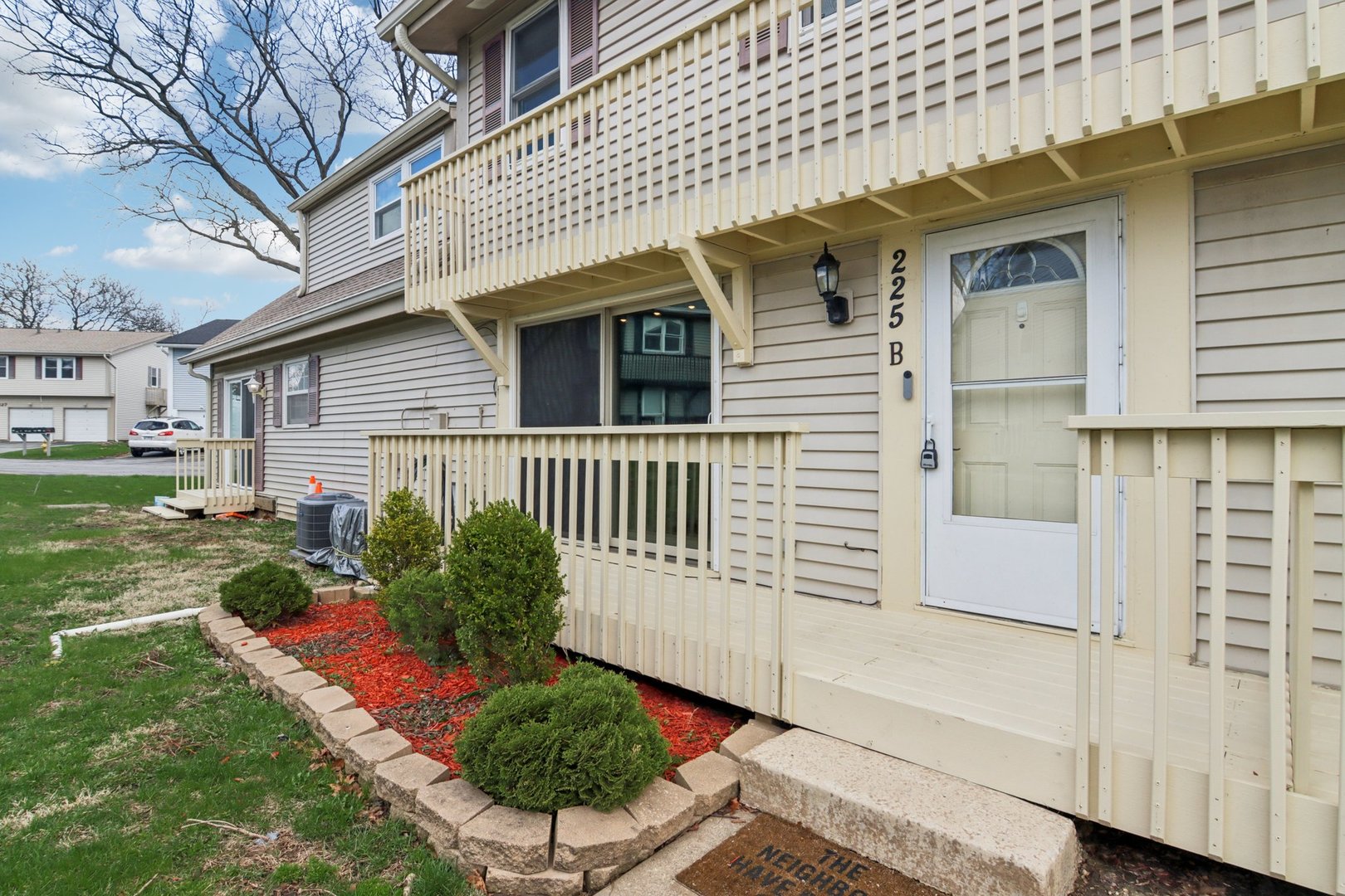 225 Foxhead Court, Unit B Bolingbrook, IL 60440 - Photo 1 of 14 a view of a house with a yard and potted plants