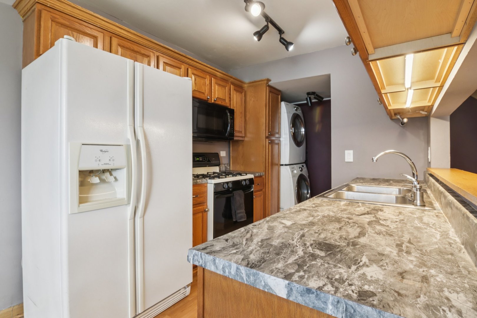 225 Foxhead Court, Unit B Bolingbrook, IL 60440 - Photo 5 of 14 a kitchen with stainless steel appliances granite countertop a refrigerator a stove and a sink with wooden floor