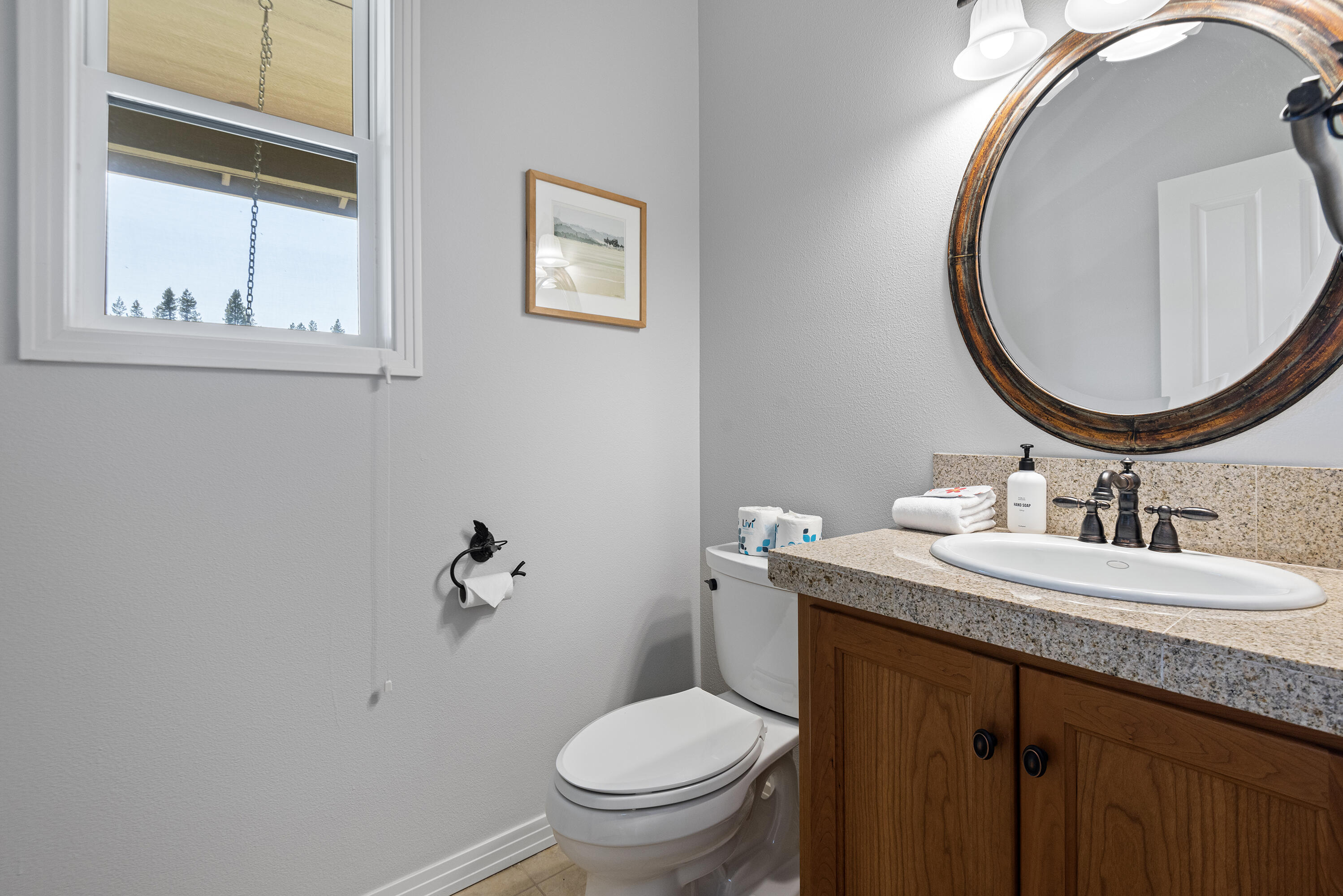 16775 Pony Express Way Bend, OR 97707 - Photo 19 of 38 a bathroom with a granite countertop toilet a sink and a mirror