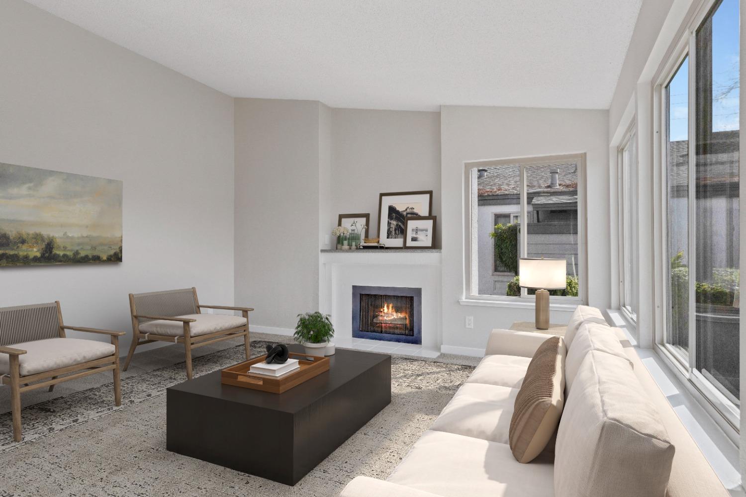 a living room with furniture fireplace and a large window