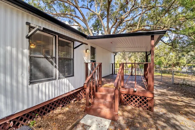 a porch with seating space and hardwood floor