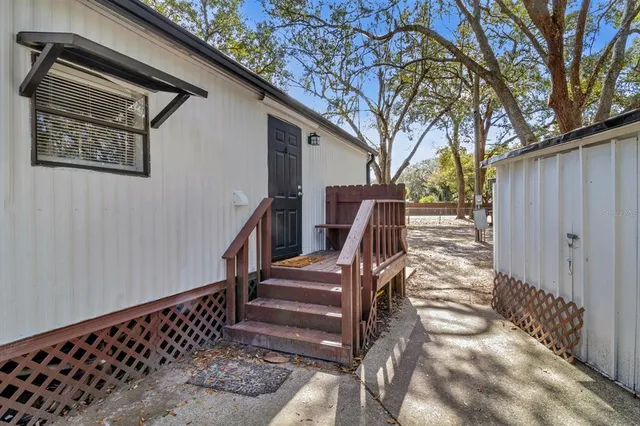 a view of stairs and yard with wooden fence