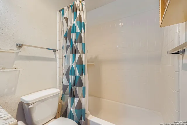 a bathroom with a sink toilet and a mirror