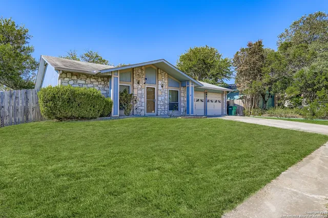 a front view of house with yard and green space