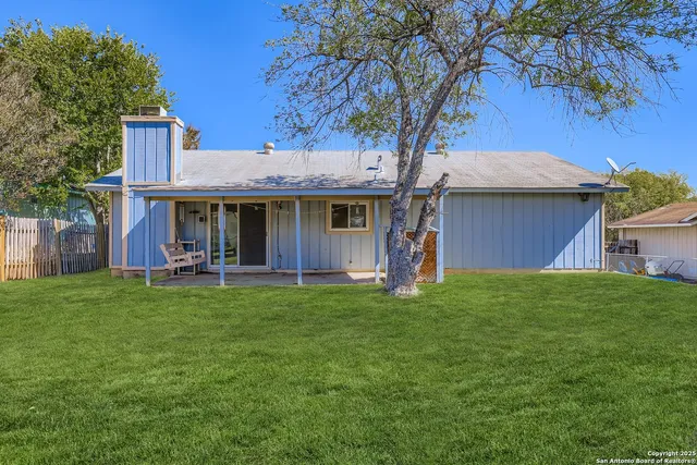 a view of a house with a backyard