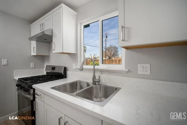 a kitchen that has a sink and a stove