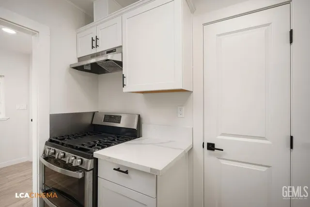 a kitchen with a stove and a refrigerator