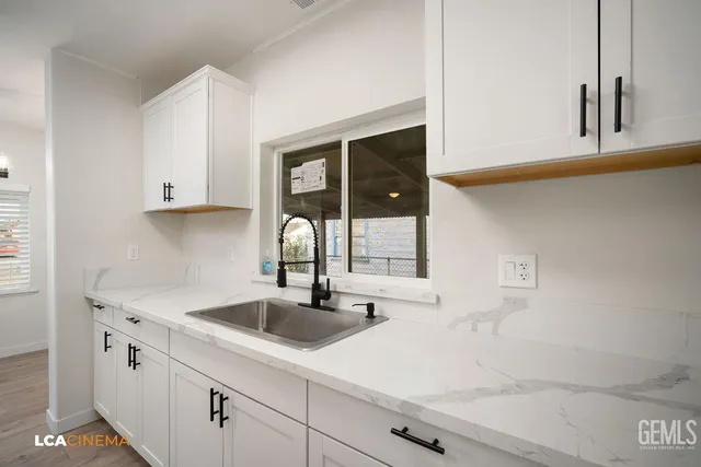 a kitchen with a sink and cabinets