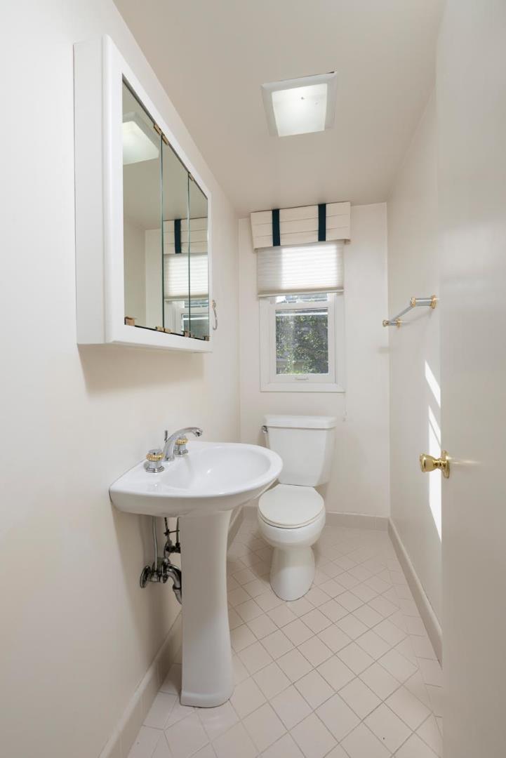 321 Ashton Avenue Millbrae, CA 94030 - Photo 16 of 18 a bathroom with a toilet sink and mirror