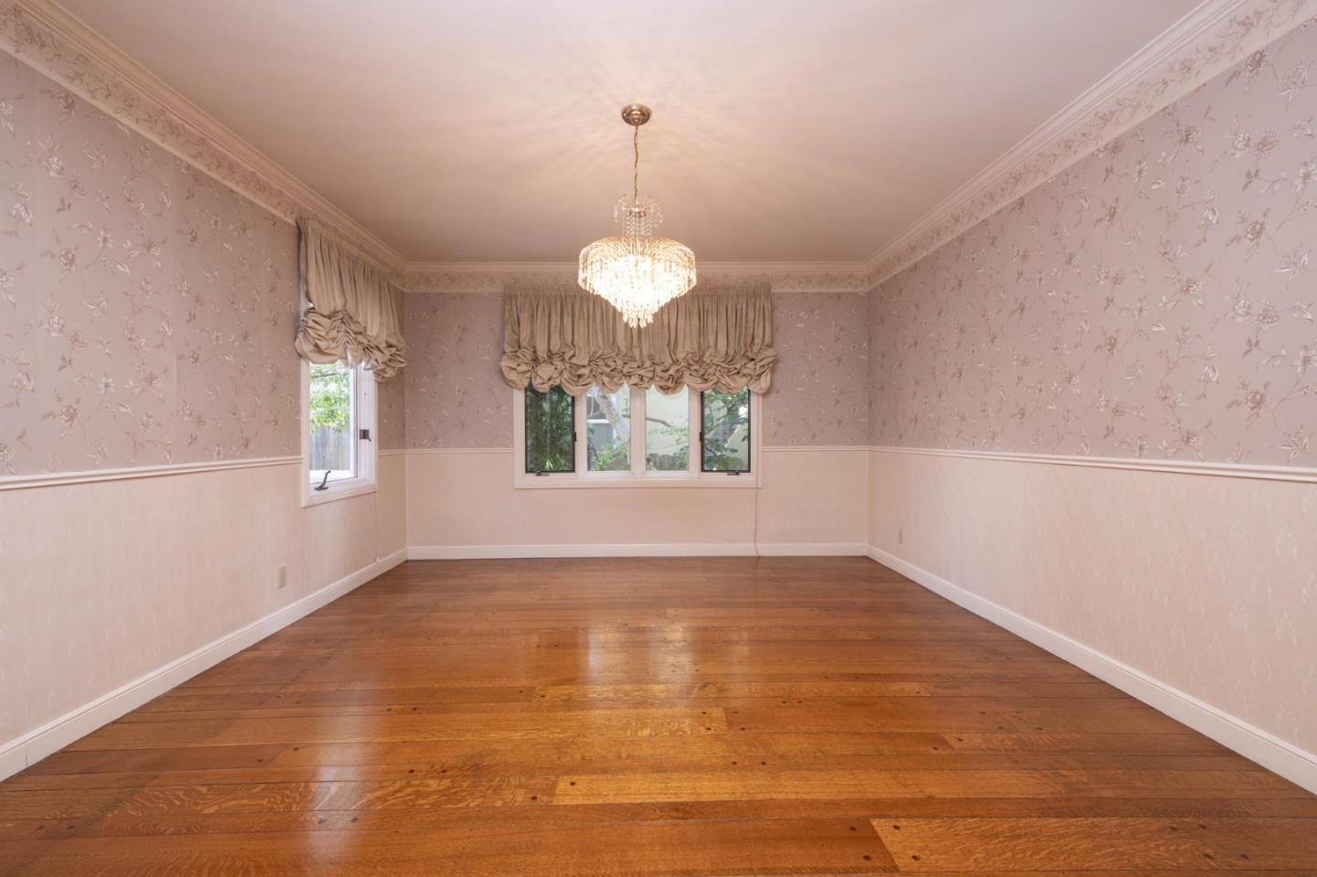 321 Ashton Avenue Millbrae, CA 94030 - Photo 5 of 18 a view of an empty room with window and wooden floor