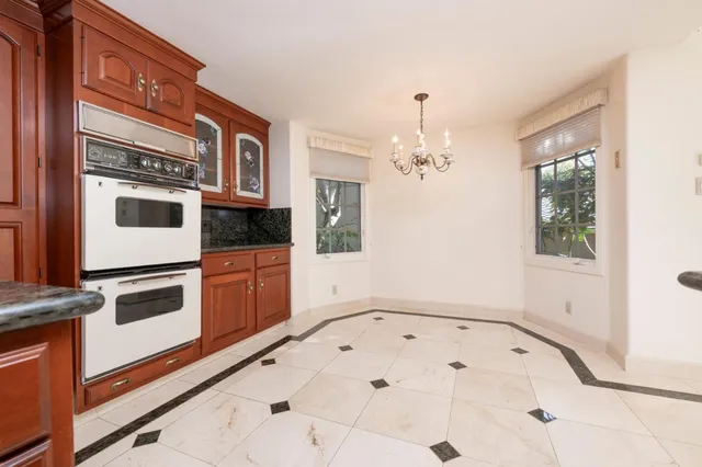 an empty room with windows and ceiling fan view