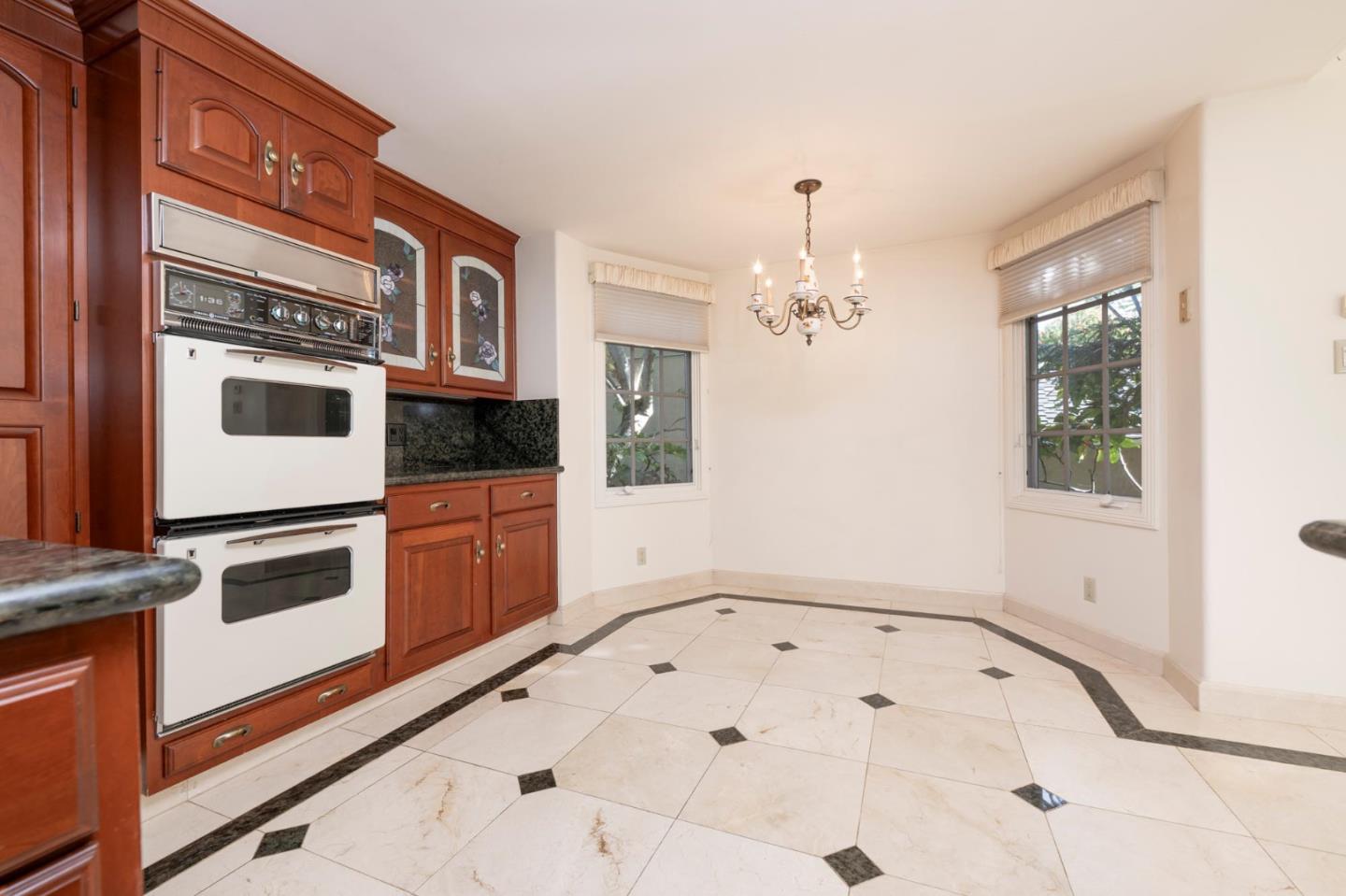 321 Ashton Avenue Millbrae, CA 94030 - Photo 9 of 18 a view of a hallway with entryway and chandelier
