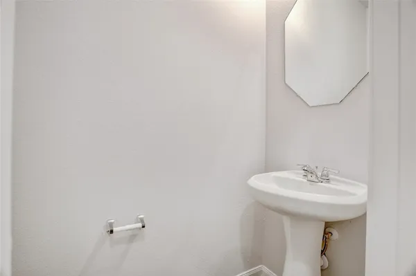 a bathroom with a sink a mirror and a toilet