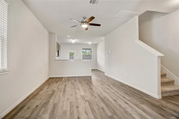 wooden floor in an empty room with a window