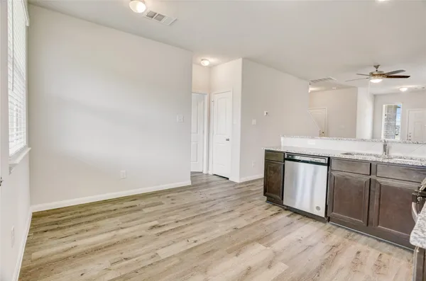 a view of a kitchen with a sink cabinets and wooden floor