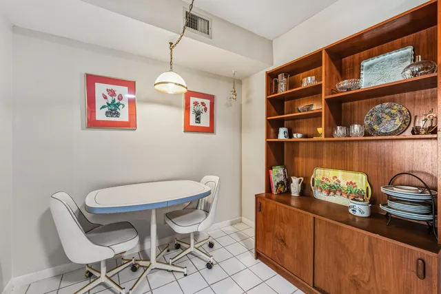 a room with a table chairs and a wooden floor