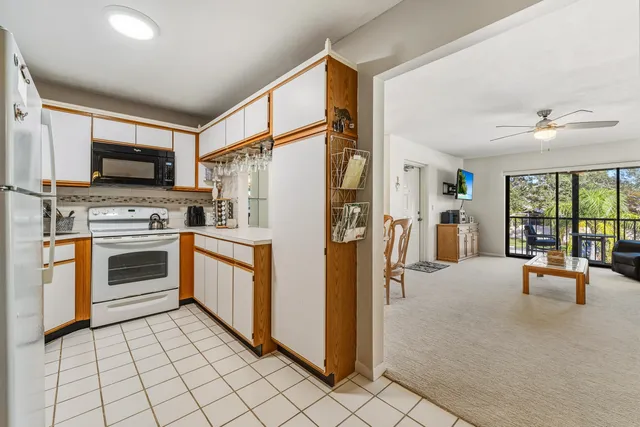 a kitchen with stainless steel appliances a stove a sink and a refrigerator