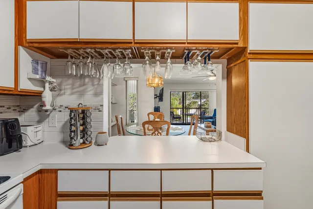 a kitchen view with table and chairs