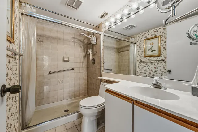 a bathroom with a sink shower and a mirror