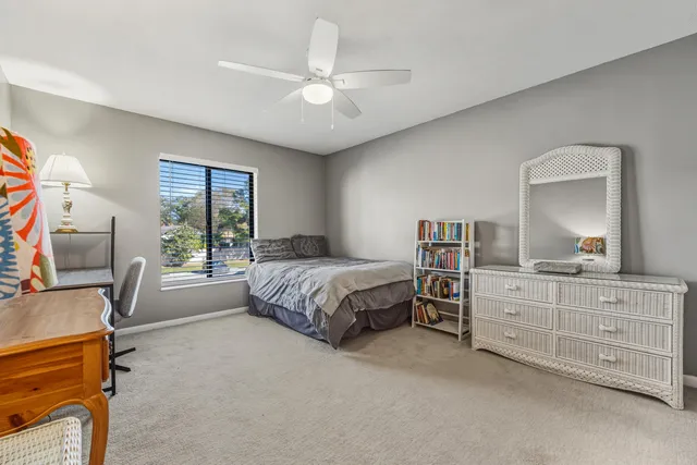 a bedroom with a large bed and a flat tv screen on dresser