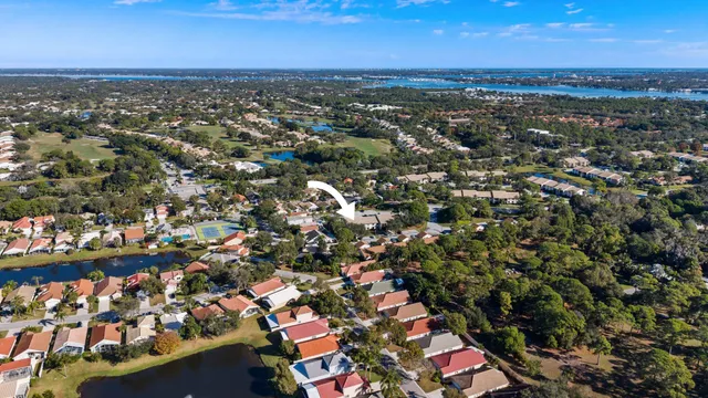 an aerial view of a city with lots of residential buildings and ocean view