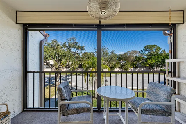 a view of a chairs and table in the balcony