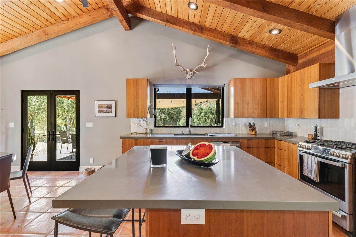 2727 Thomas Road Hollister, CA 95023 - Photo 47 of 83 a kitchen with stainless steel appliances a table chairs and a wooden floor