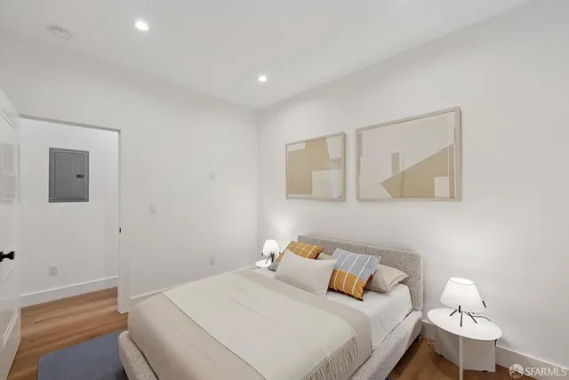 a bedroom with a bed and a painting on the wall