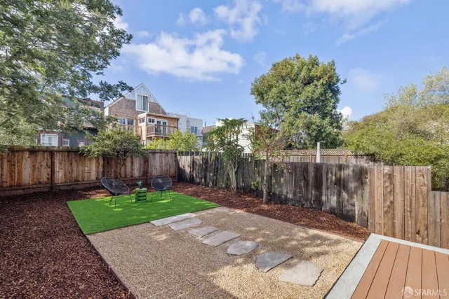 a view of a backyard with wooden fence