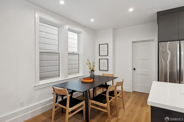a view of a dining room with furniture and wooden floor