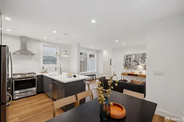 a kitchen with stainless steel appliances granite countertop a sink and a refrigerator