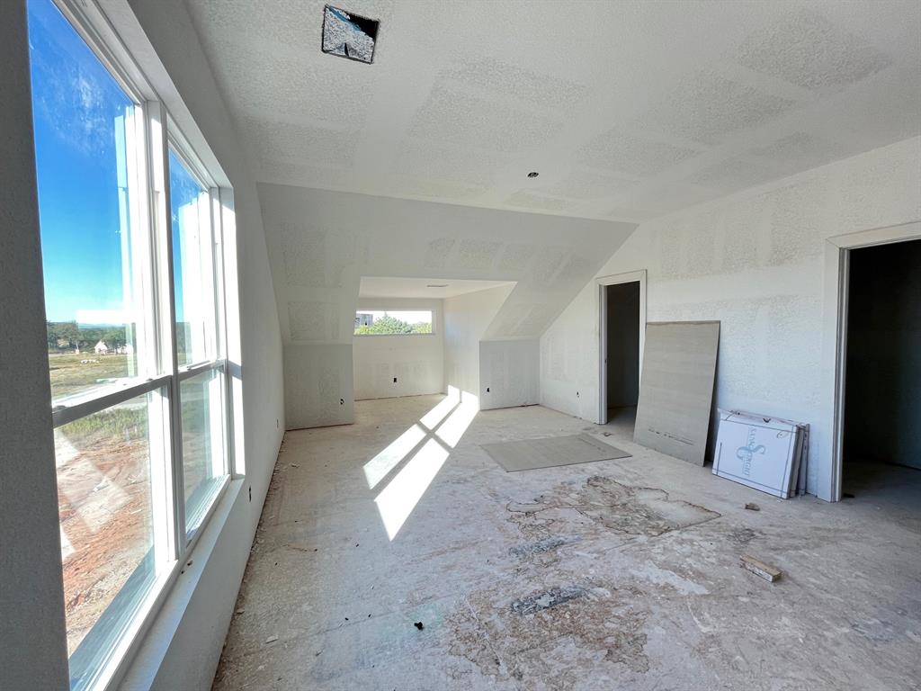 320 Jonny Boy Way Springtown, TX 76082 - Photo 3 of 4 Bonus room with a textured ceiling and lofted ceiling