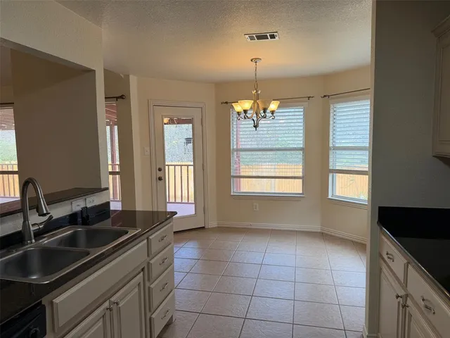 a kitchen with a sink stove and cabinets