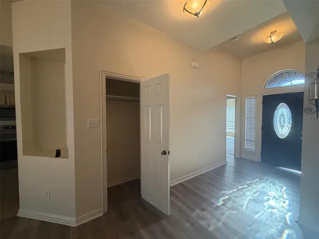 a view of hallway with wooden floor